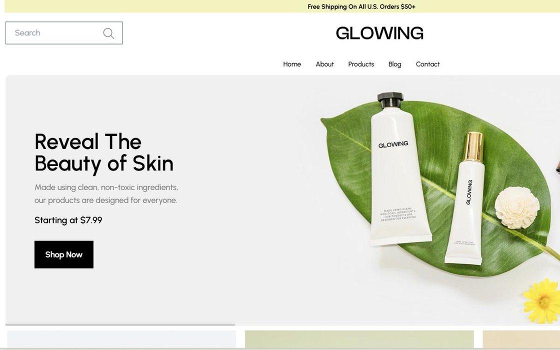 Glowing skincare homepage with cosmetic products arranged on a green leaf
